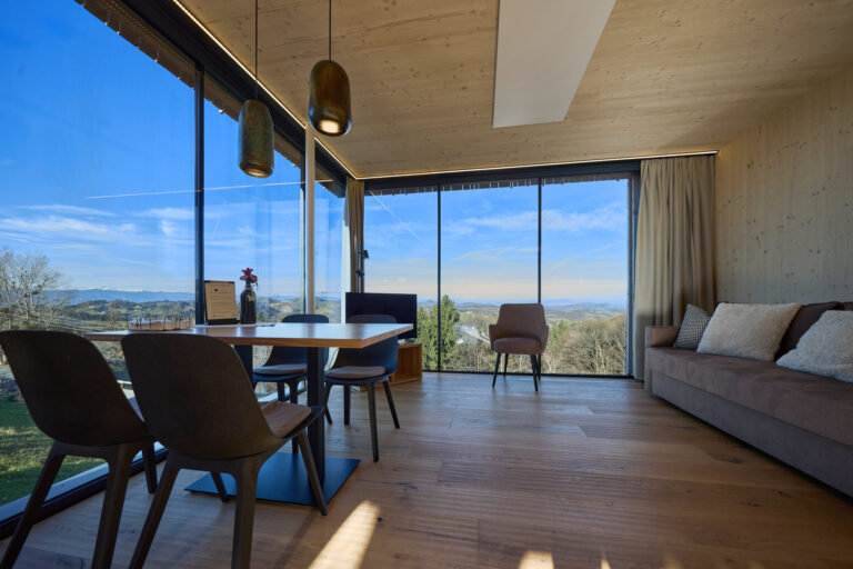 Rosen Lodge living and dining area with large windows overlooking the countryside